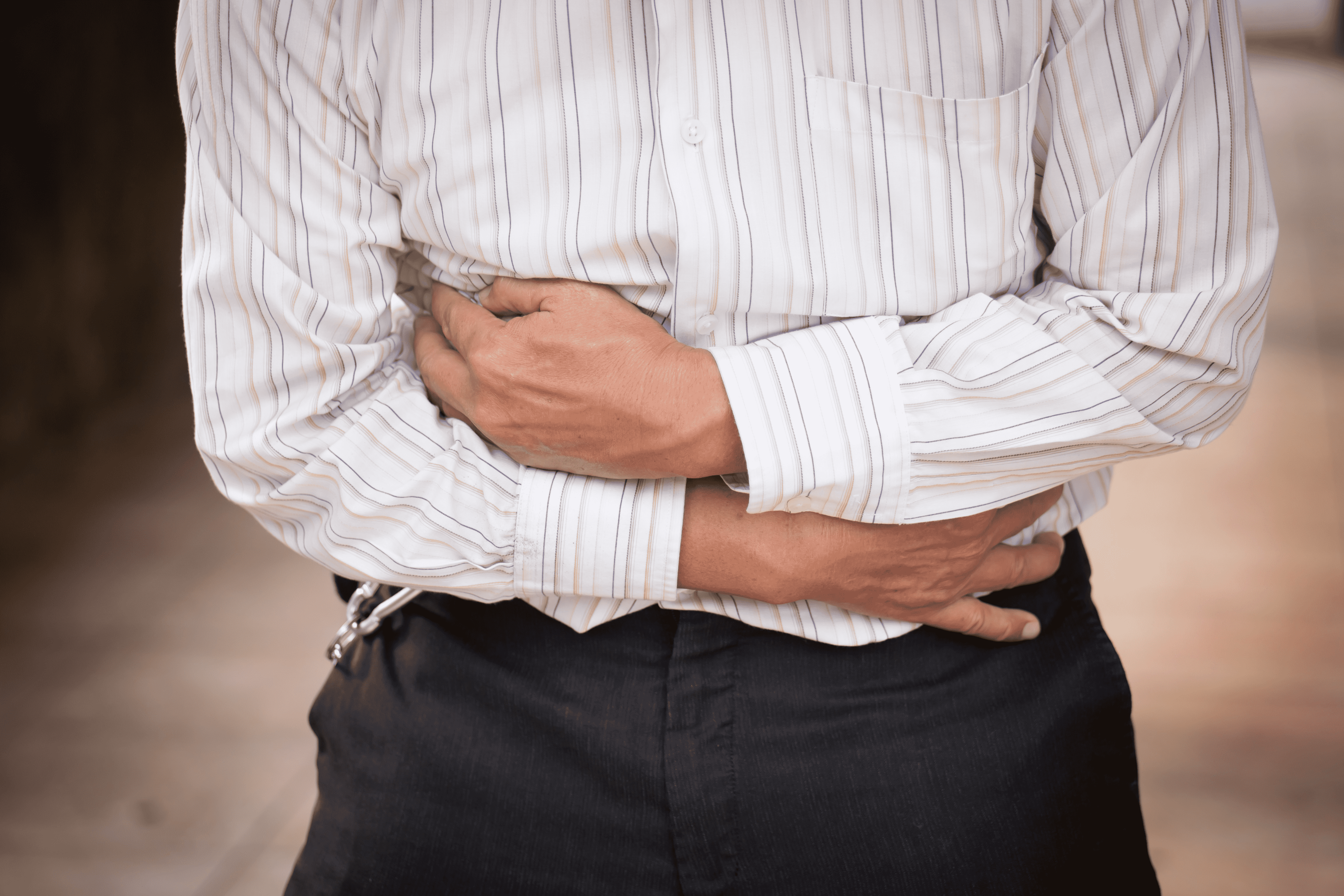 Man Clenching Stomach